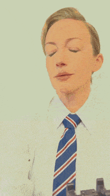 a woman wearing a striped shirt and a blue tie