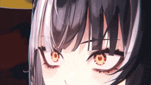 a close up of a girl 's eyes with a very angry expression