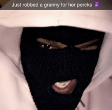 a person wearing a ski mask with the words just robbed a granny for her percks