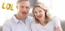 a man and woman are sitting next to each other on a couch .