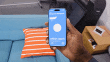 a person holding a phone that says within reach on it