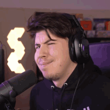a man wearing headphones making a funny face