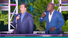 two men standing on a stage with microphones in front of a nbc screen that says american ninja warrior