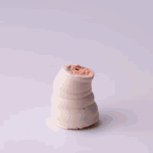a person is decorating a cake with whipped cream on top