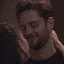 a man and a woman kissing in a dark room