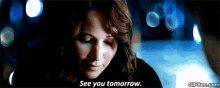 a woman in a dark room says see you tomorrow .