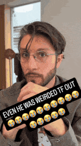 a man with glasses and a beard holds a sign that says even he was weirded tf out