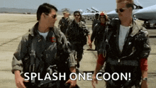 a group of military men are walking down a runway .