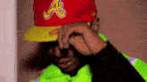 a man wearing a red and yellow hat with the letter a on it .