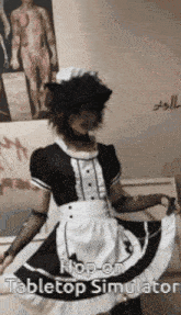 a person in a maid costume is standing in front of a wall with a picture of a man on it .