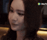 a close up of a woman 's face with the wetv logo in the background