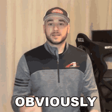 a man wearing a hat says obviously in front of a sparco chair