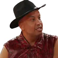 a man wearing a hat and a snakeskin shirt