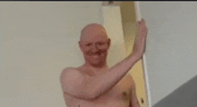 a shirtless man is standing in a doorway with his arm outstretched