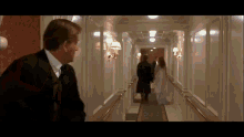 a man in a suit and tie is standing in a hallway
