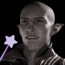 a black and white photo of a bald man with a purple wand that says alice on it