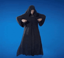 a man in a black robe with a hood on his head