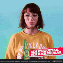 a woman wearing a yellow shirt with a bottle of reddy 's