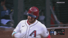 a baseball player wearing a white jersey with the letter a on it is running on the field