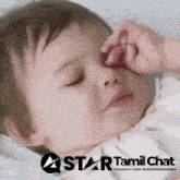 a baby is sleeping with a star tamil chat logo behind it