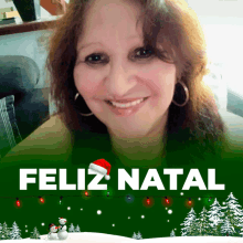 a woman in a santa hat is smiling in front of a green background that says feliz natal