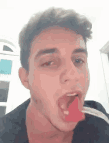 a young man is eating watermelon with a fork .