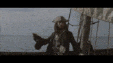a man in a pirate outfit is standing on a boat