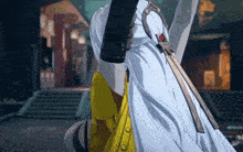 a person holding a sword in a video game with a yellow jacket