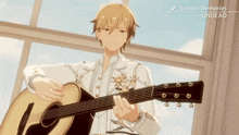 a man in a white suit is playing an acoustic guitar in front of a window