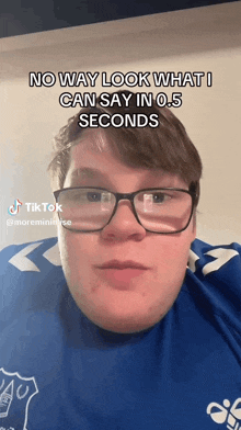 a man wearing glasses and a blue shirt with the words no way look what i can say in 0.5 seconds on the bottom