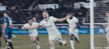 a soccer player in a white jersey with the number 1932 on it