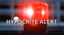 a red emergency light with hypocrite alert written below it