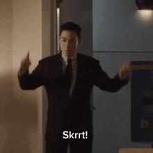 a man in a suit and tie is dancing and the word skrrt is above him