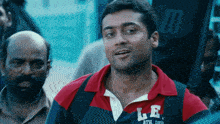 a man wearing a le athletic dept shirt looks at the camera