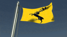 a yellow and black flag with a deer on it