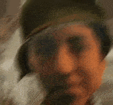 a man wearing a helmet is looking at the camera .