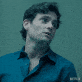 a close up of a man 's face with a netflix logo behind him