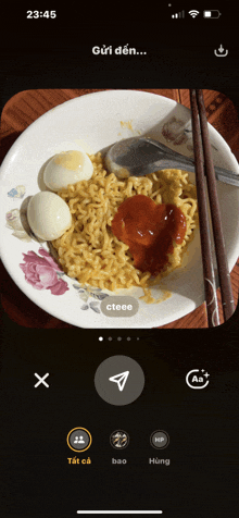 a phone screen shows a plate of noodles with eggs and sauce