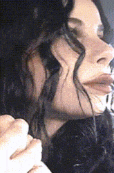 a close up of a woman 's face with her eyes closed and her mouth open