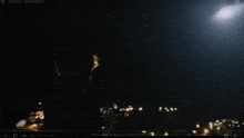 a person is looking at a comet in the sky