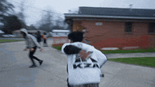 a person wearing a white shirt that says kia