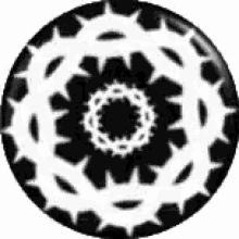 a black and white circle with a crown of thorns on it