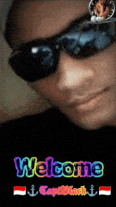 a picture of a man wearing sunglasses and the words welcome on the bottom