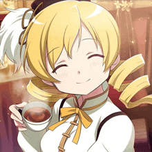 a girl with blonde hair is holding a cup of tea