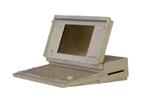 a very old apple computer with a keyboard