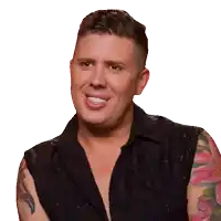 a man with tattoos on his sleeves is smiling for the camera