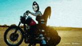 a cartoon character is riding a harley davidson motorcycle in the desert