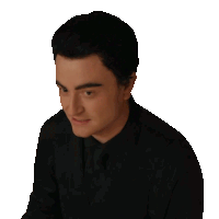 a man in a black suit and tie is looking to the side