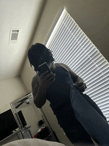 a man is taking a picture of himself in a mirror