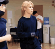 a man wearing a blue sweater with the letters pjm on it